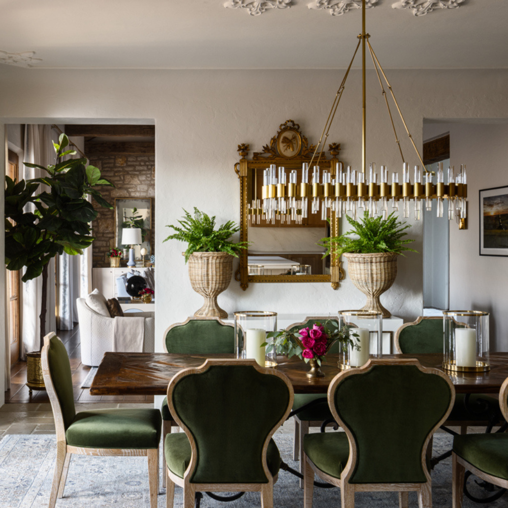 Dining room with a wooden table, green chairs, and decorative elements.