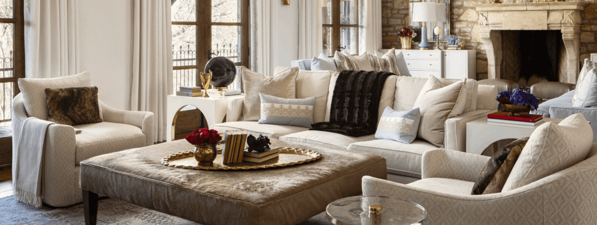 Living room with beige sofas, a coffee table, and decorative items.