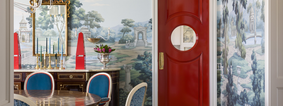 Decorative interior with a red door and wall art